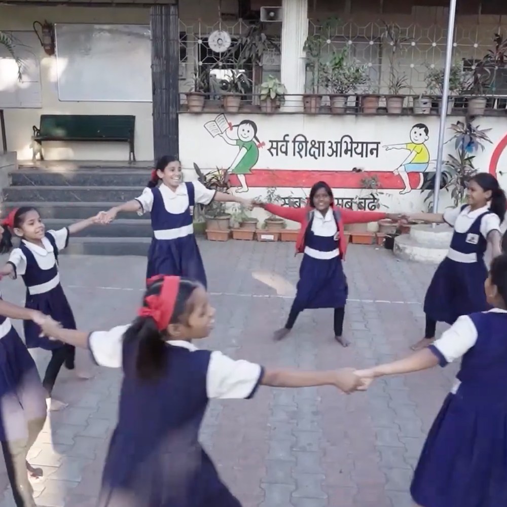Schoolgirls playing in a circle in the courtyard